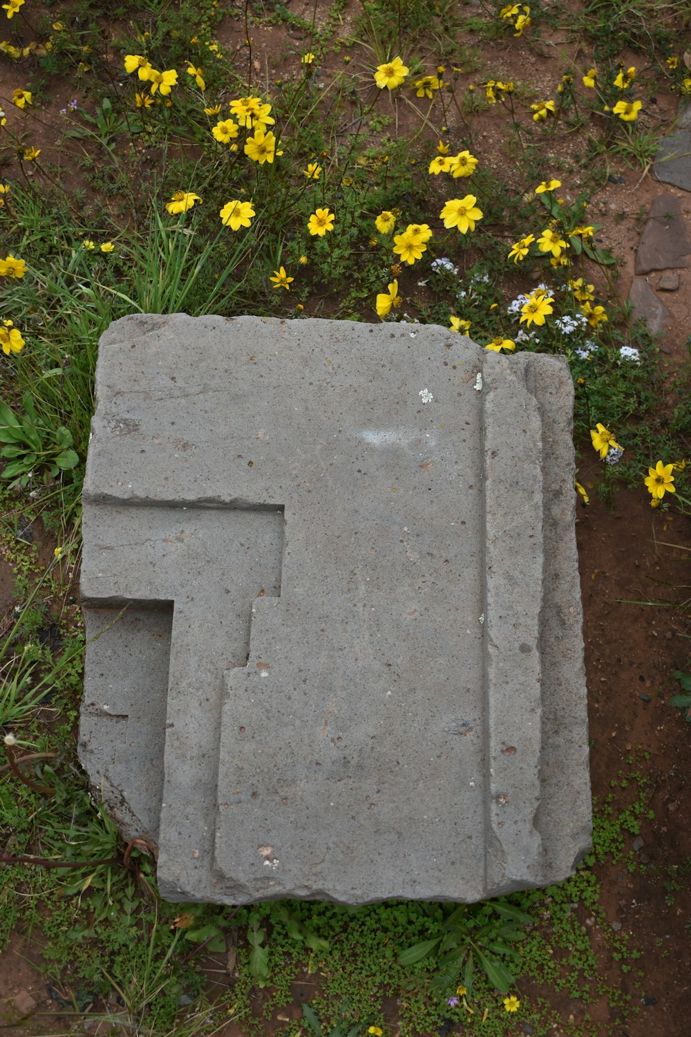 a tombstone with flowers on it