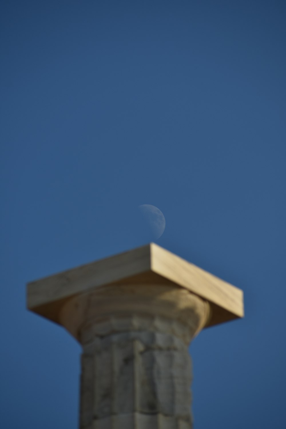 a stone building with a moon in the sky