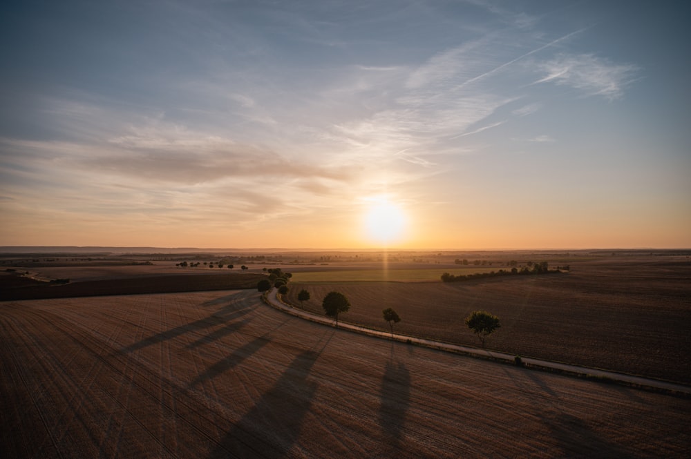 a large field with a sunset