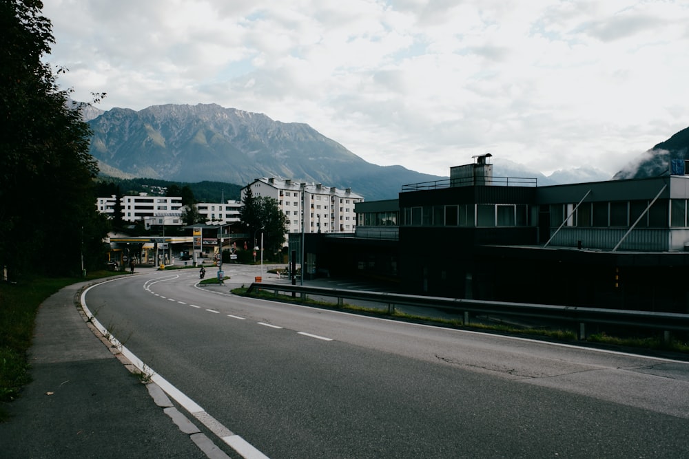 a road with buildings and trees on the side