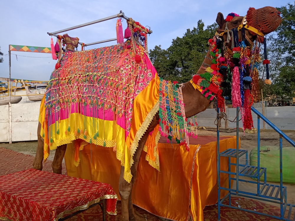 a large elephant with colorful blankets