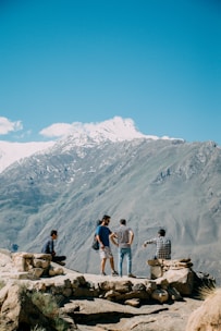 A group of friends enjoying a picturesque view from a mountain top.