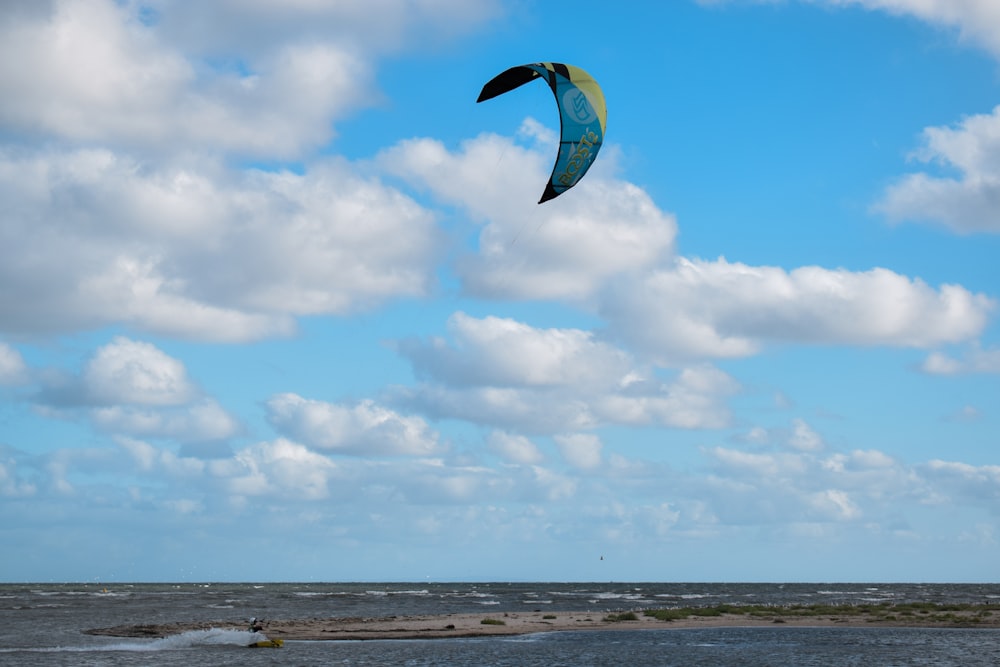 a person flying a kite on the beach