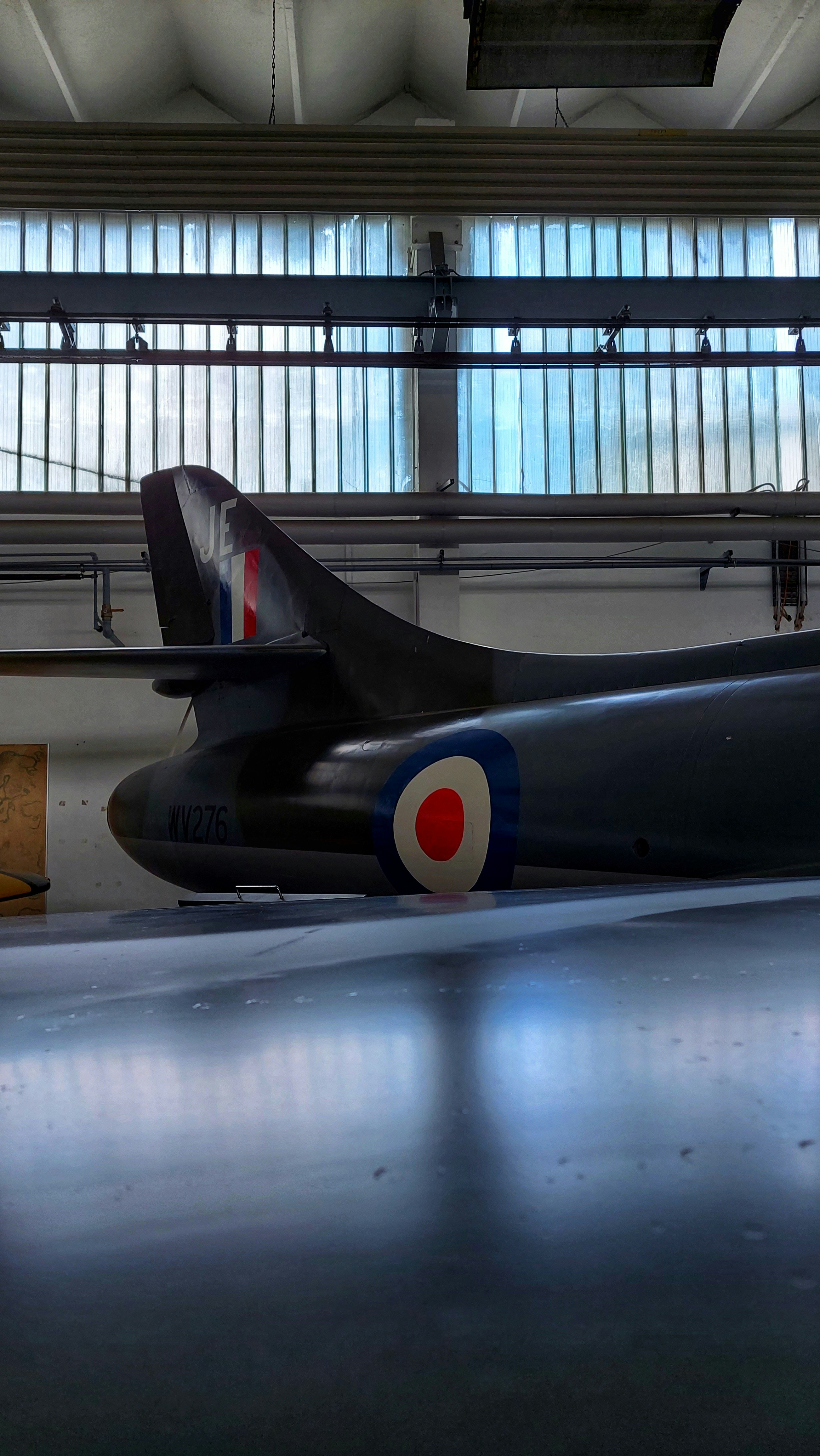 a black airplane in a hangar