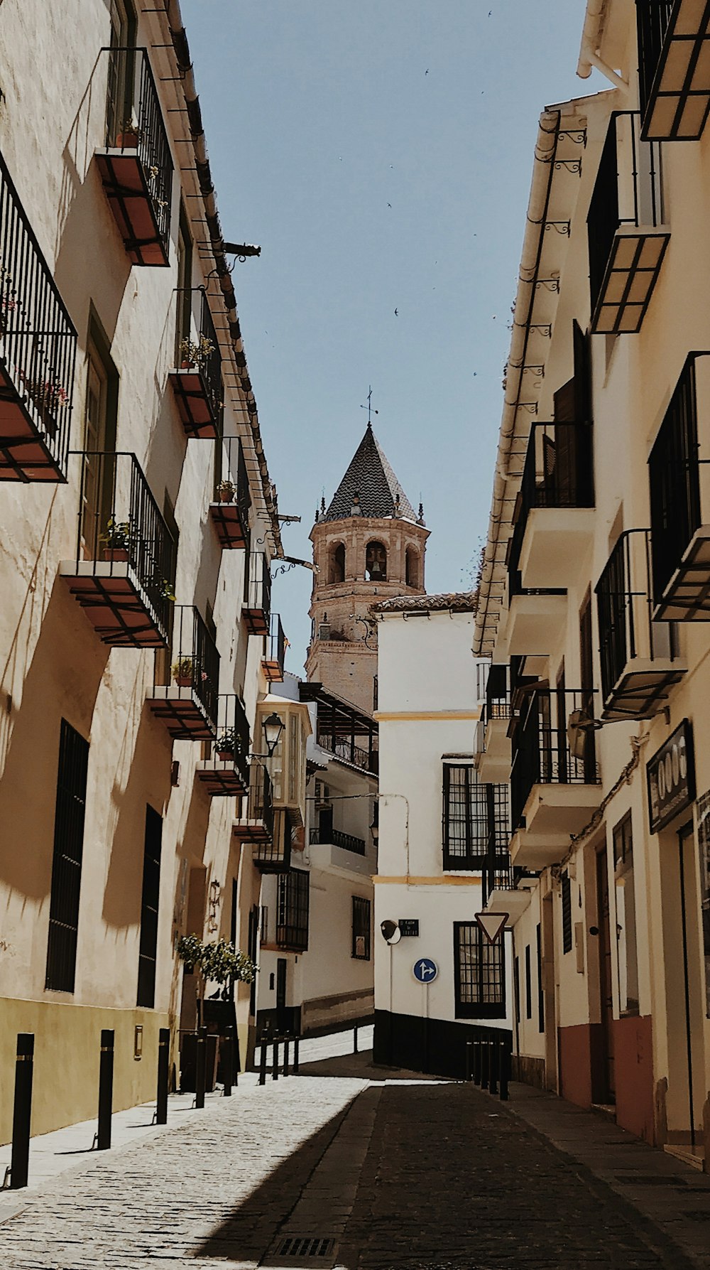 a cobblestone street with buildings on both sides