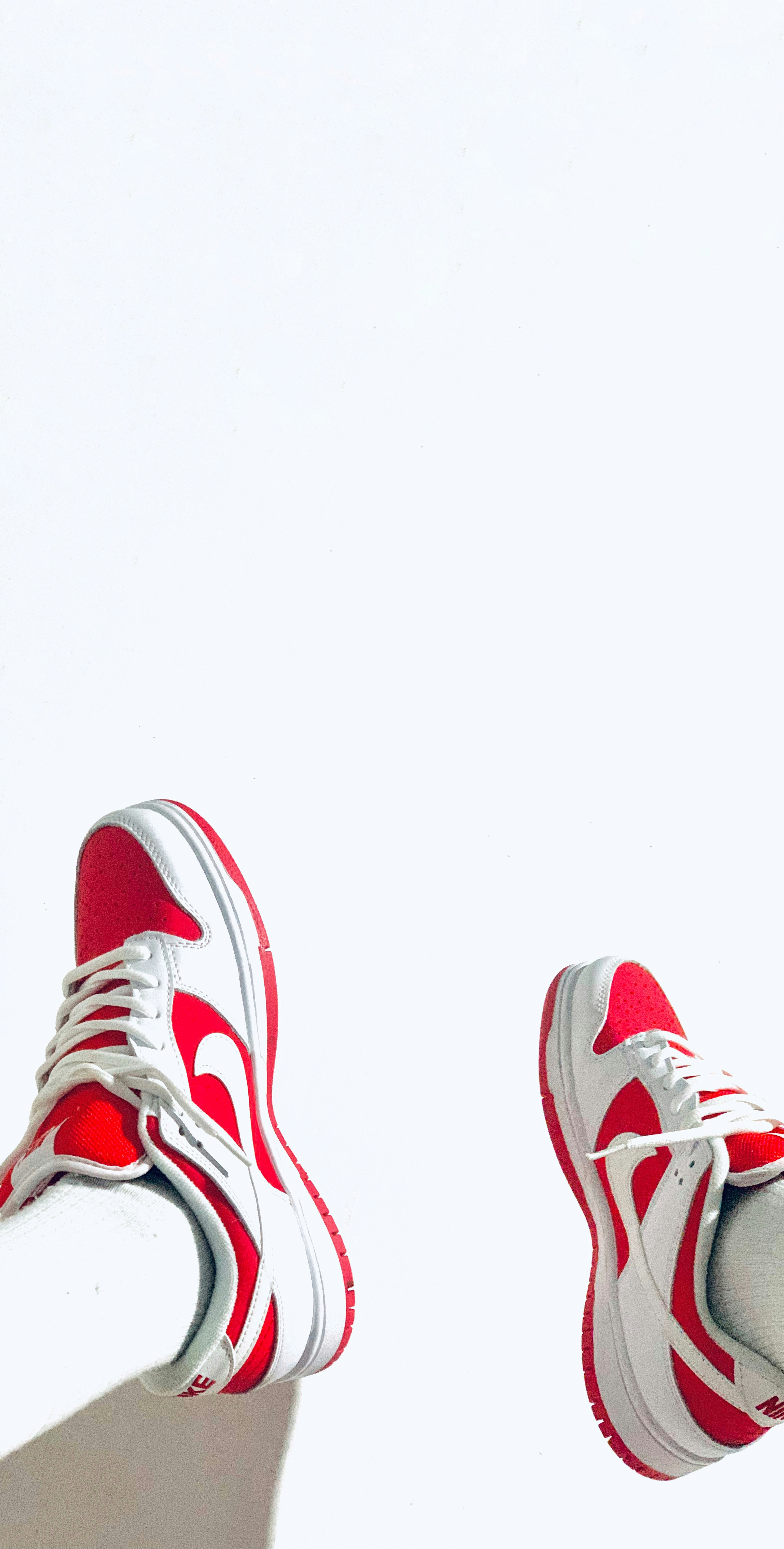 a pair of red and white sneakers