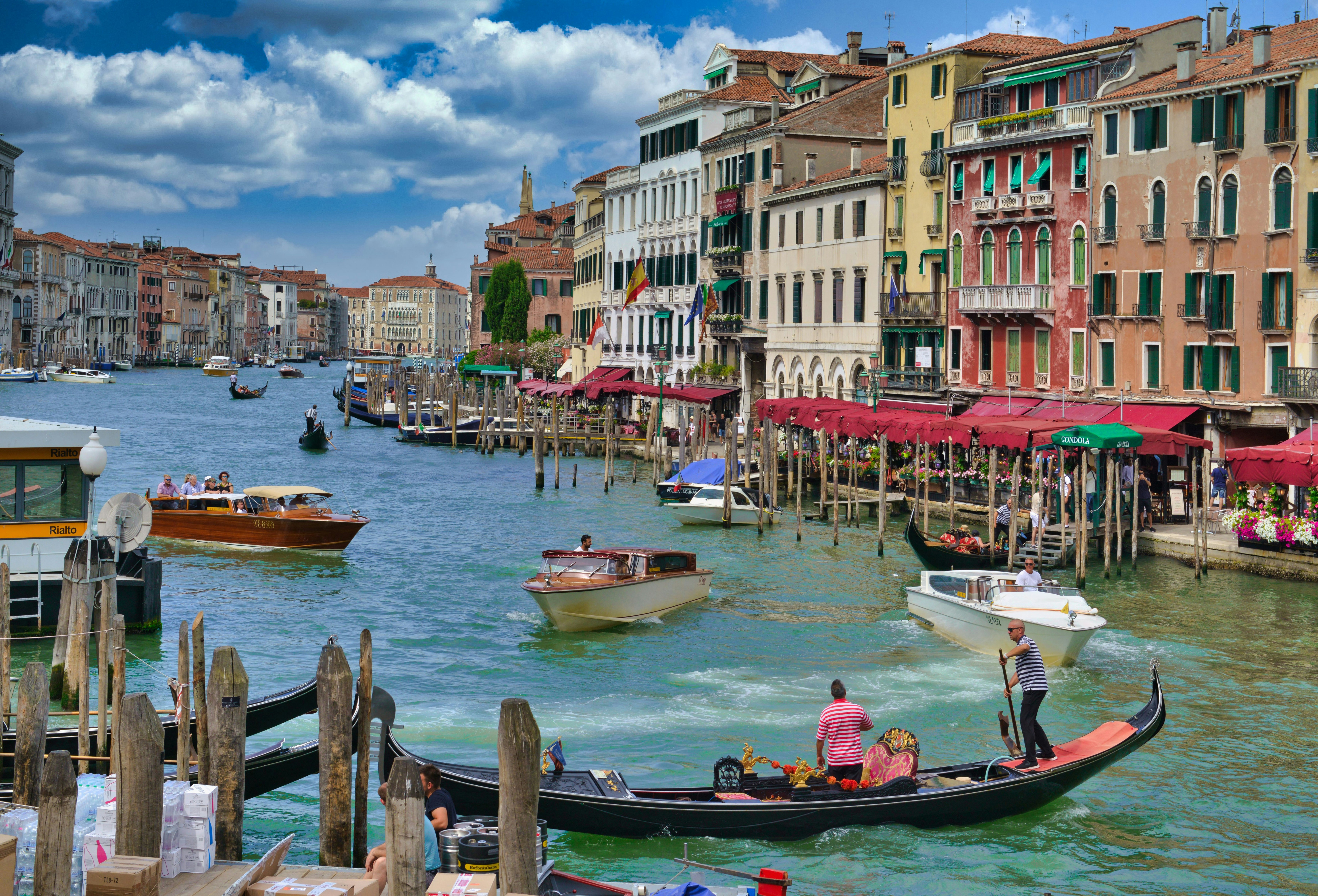 a group of boats in a canal, Venice in summer time, Italy