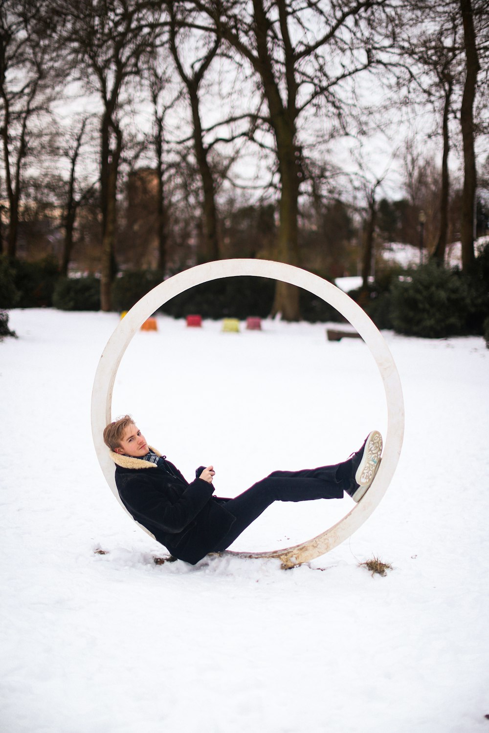 a man lying on a slide in the snow