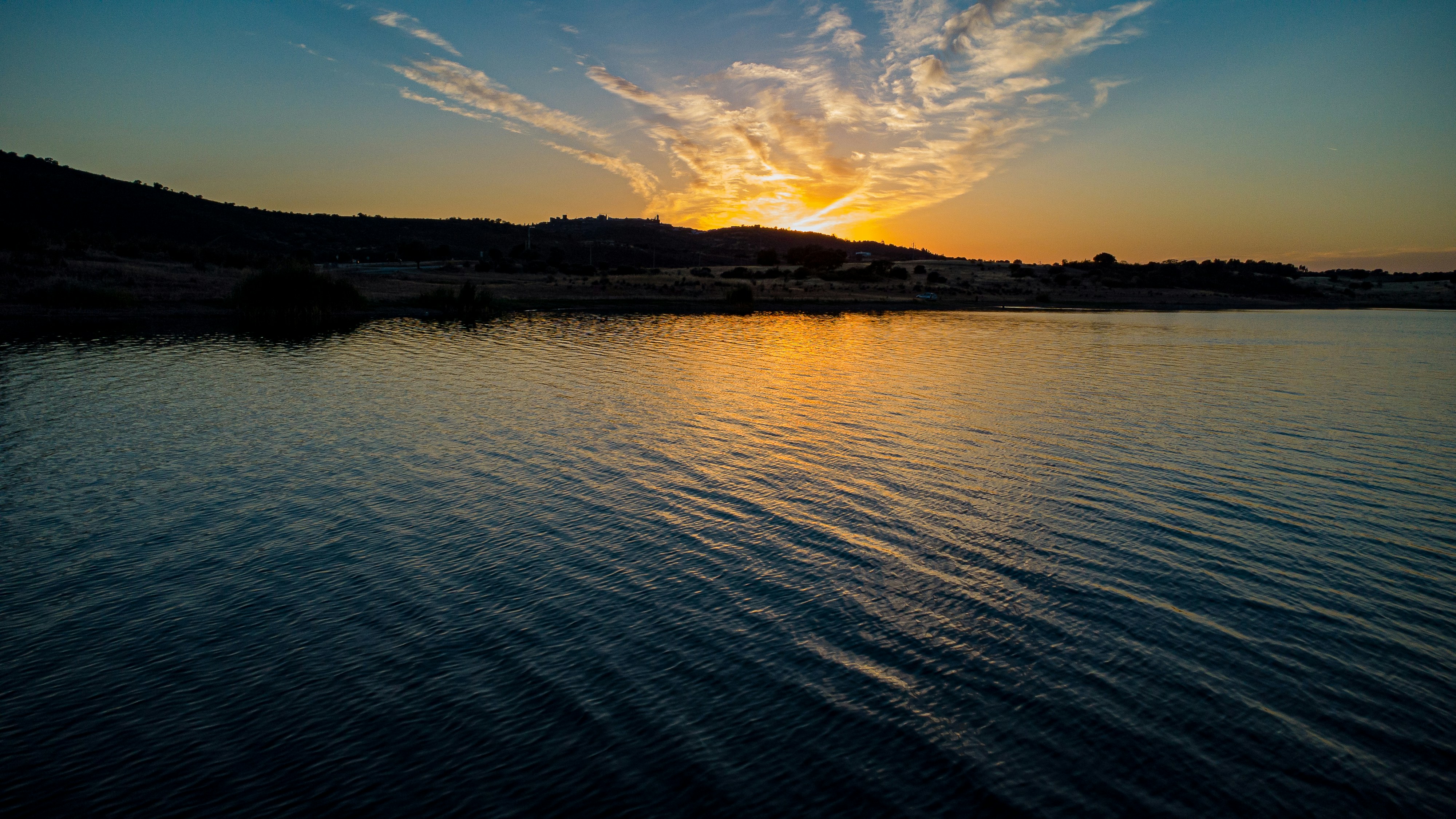 a body of water with a sunset
