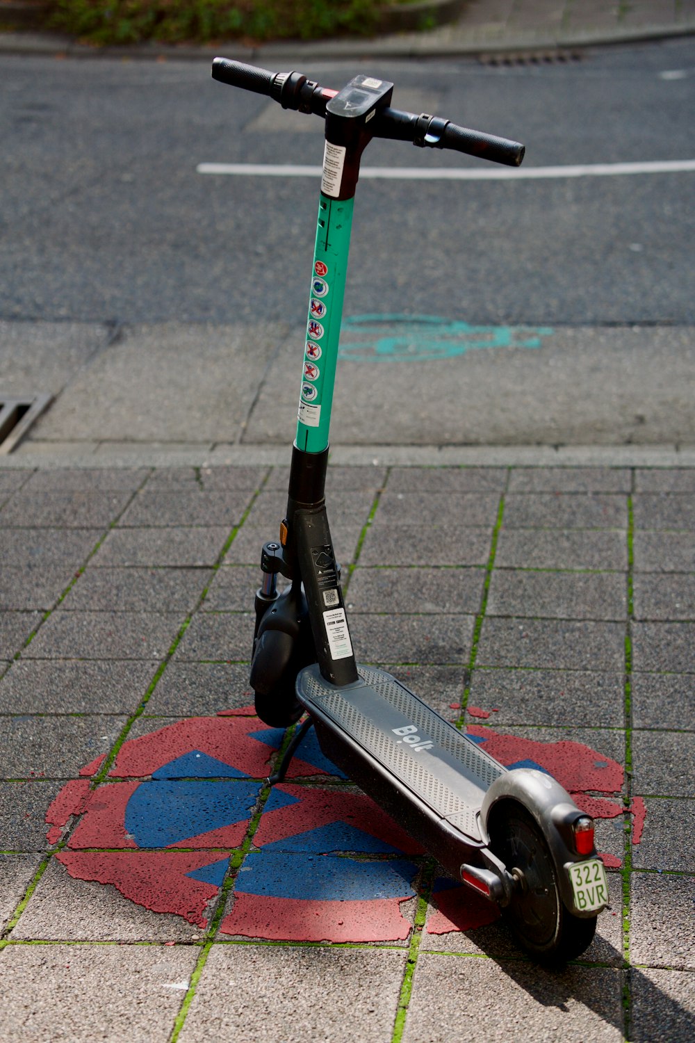 a scooter parked on a sidewalk