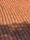 Rows of overlapping terracotta roof tiles, creating a repeating geometric pattern. The tiles have a weathered appearance, with some areas showing signs of moss or dirt accumulation.