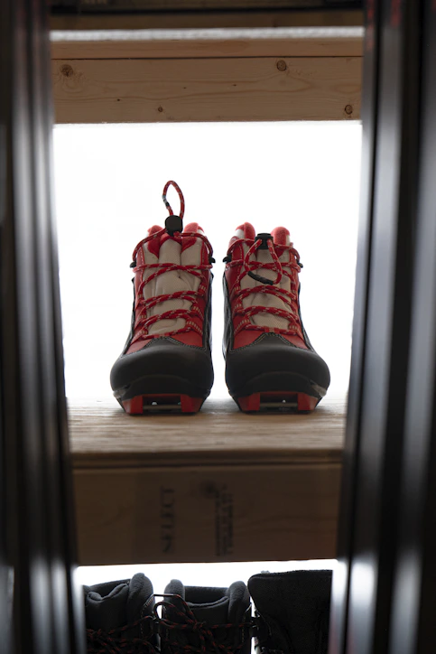 a pair of red shoes on a window sill