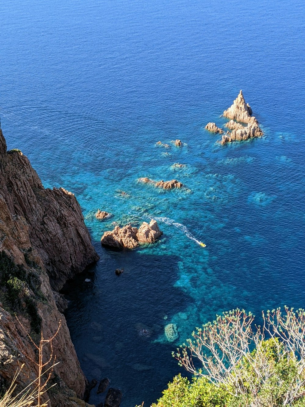 a rocky beach with blue water