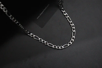 Pure platinum chains displayed on a sleek black background highlighting their cool luster.