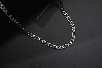 Close-up of sleek silver chains shining under soft light.