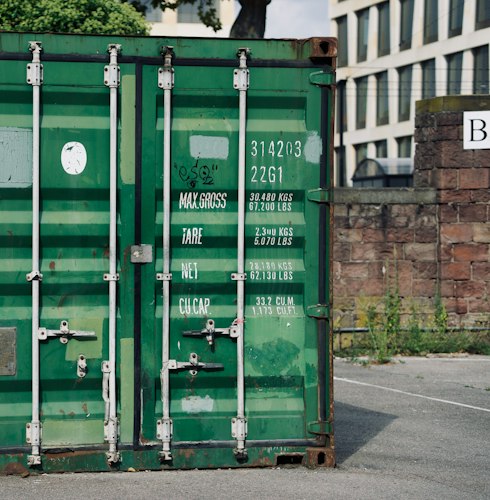 Rows of shipping containers stacked at a port, a common visual metaphor for software containers
