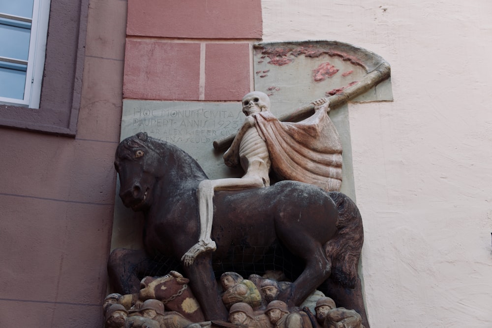 a statue of a person riding a horse