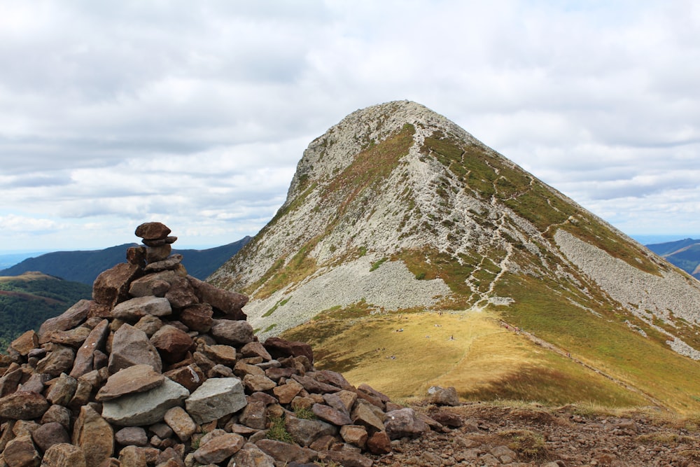 a rocky mountain with a lake below