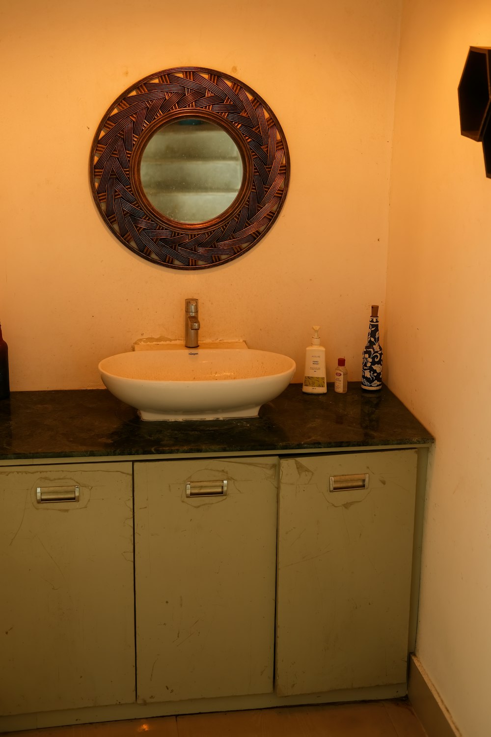 a bathroom with a round mirror