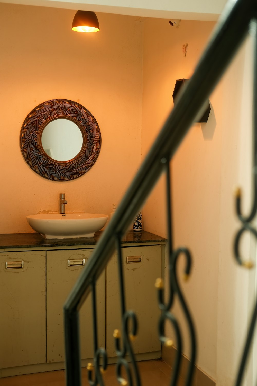 a bathroom with a round mirror