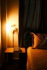 Cozy bedroom corner featuring elegant curtains and warm lighting.