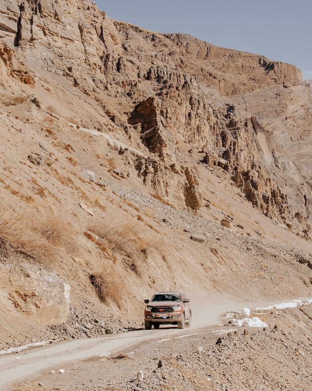 a truck driving through a rocky terrain