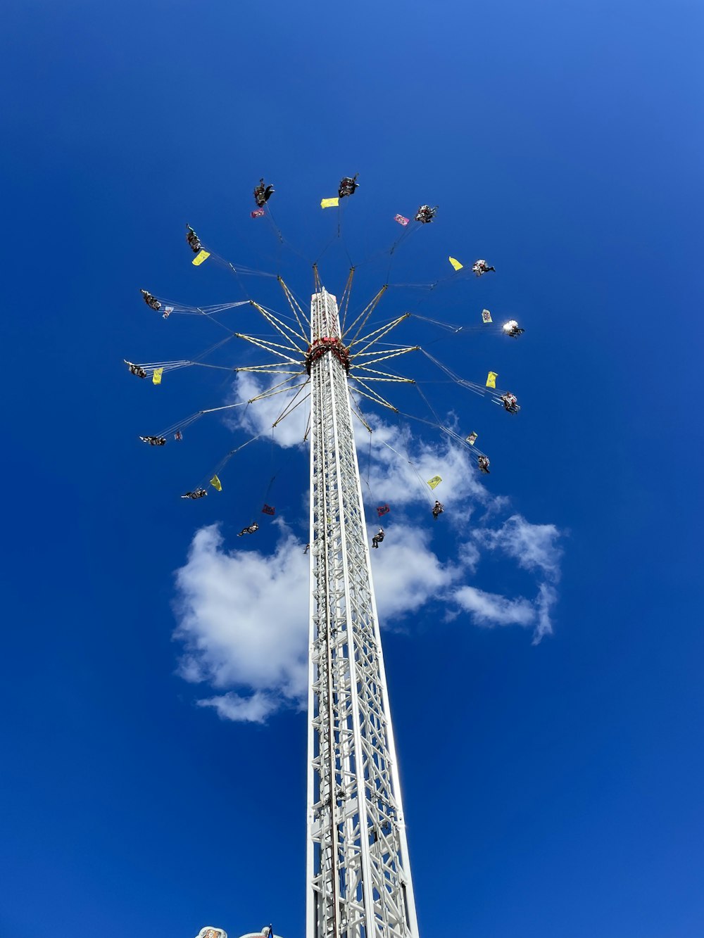 a tall tower with kites flying in the sky