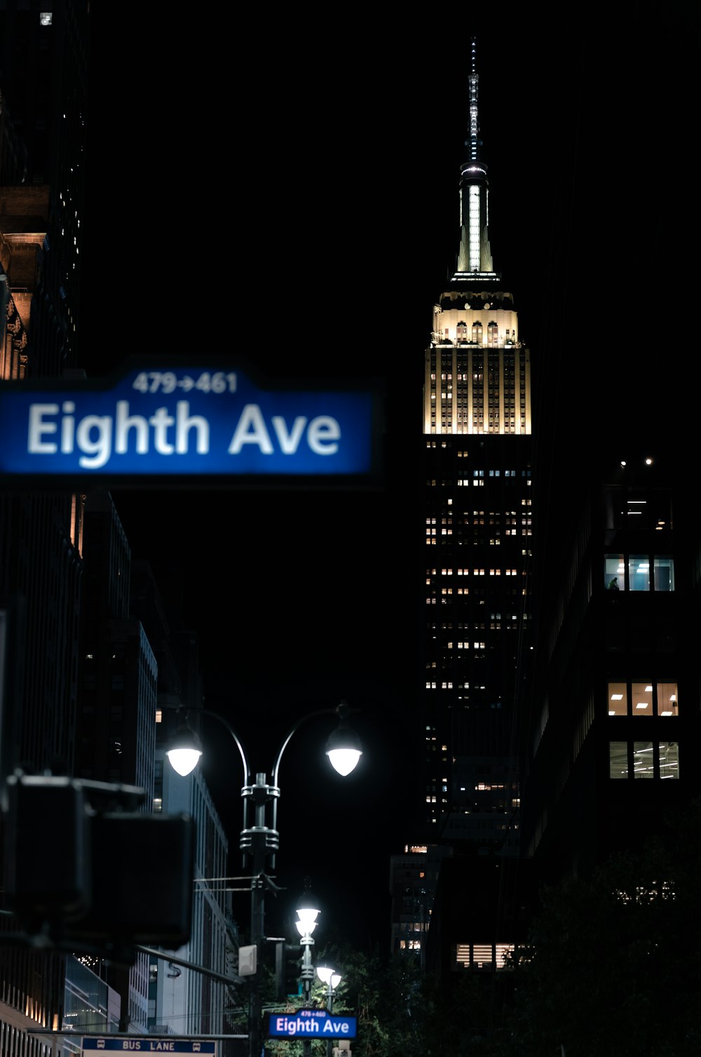 a sign in front of a tall building