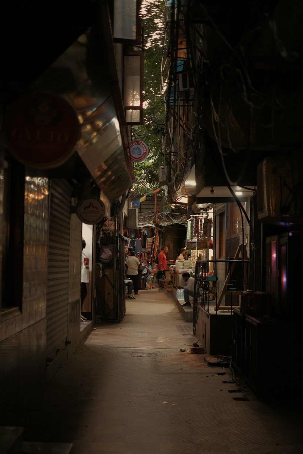 people walking down a narrow alley