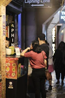 A bustling Prata Alley outlet with smiling staff serving happy customers.