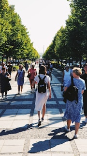 a group of people walking on a sidewalk