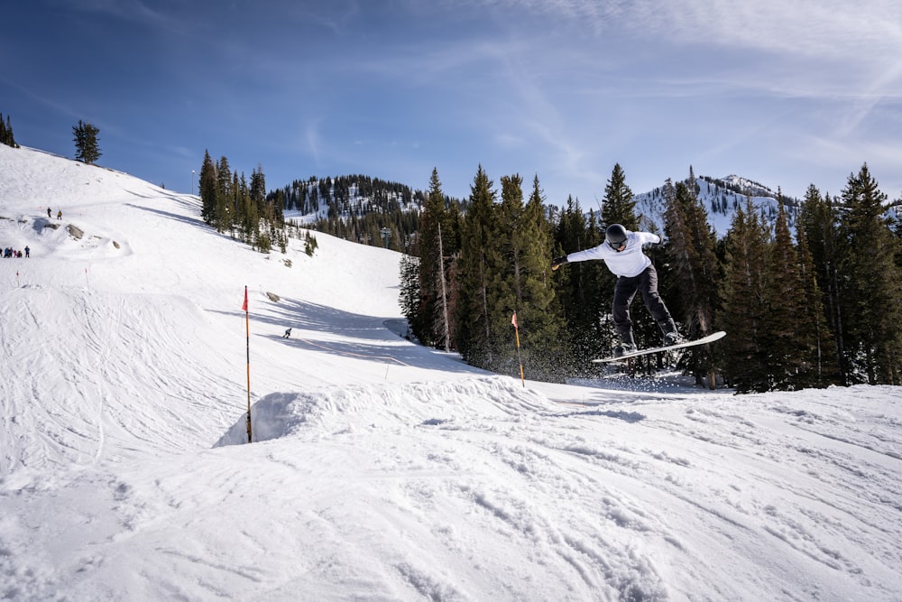 a person jumping in the air on a snowboard