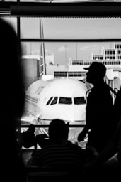 a man stands next to a plane