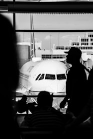 a man stands next to a plane