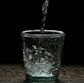 a glass of water with a black background