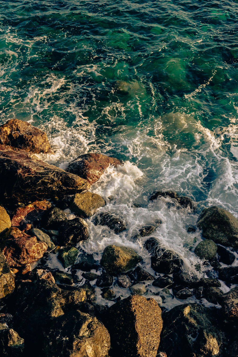 a rocky beach with waves crashing