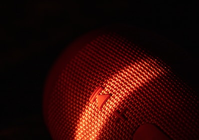 Close-up of a smart textile embedded with sensors, illuminated with soft gradient lighting.