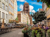A historic European city street lined with charming cafes and cobblestone paths.