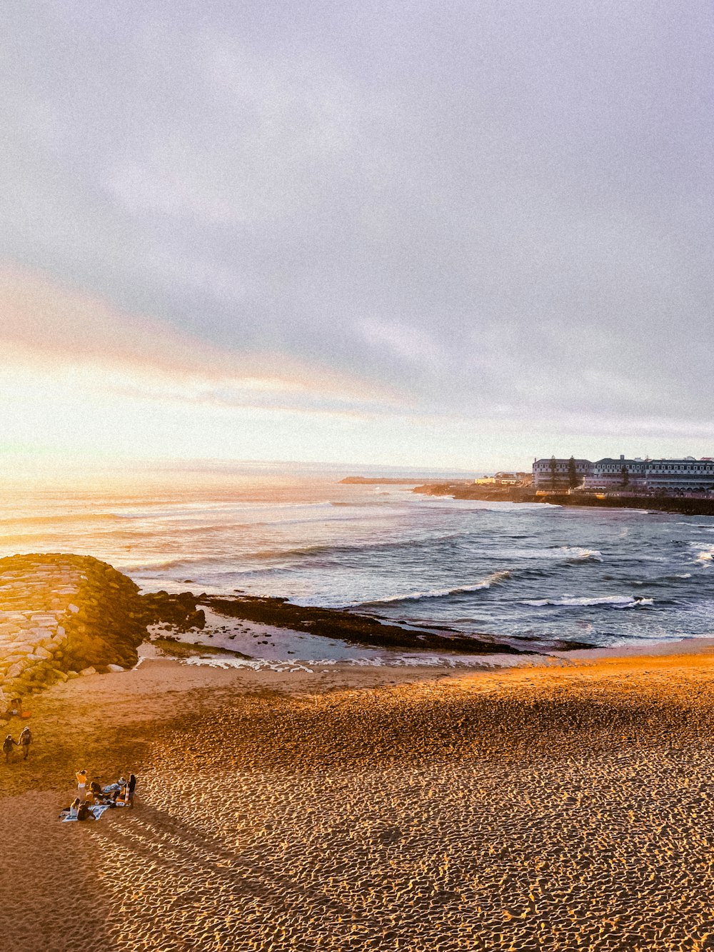 a beach with a building in the distance