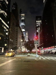 A clean, modern cab waiting outside a busy city street at sunset.
