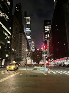 A clean, modern cab waiting outside a busy city street at sunset.