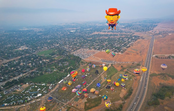 a group of hot air balloons over a cityby Manny Becerra