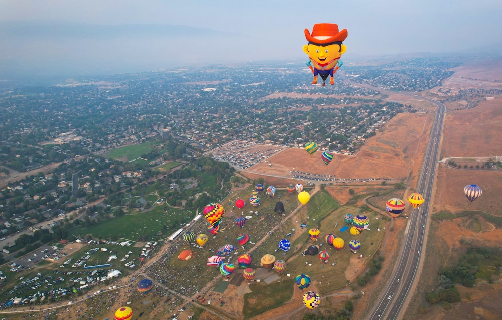 a group of hot air balloons over a city