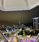 Evening cityscape with glowing lights from a cultural street fair