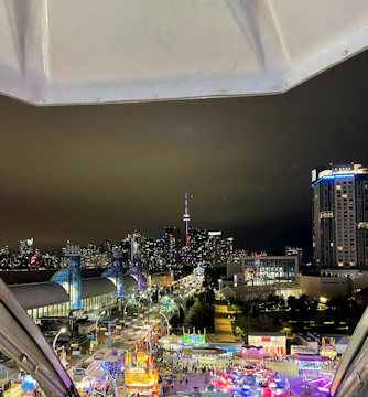 Evening cityscape with glowing lights from a cultural street fair