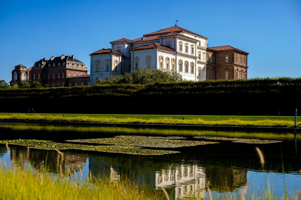 a large building with a pond in front of it