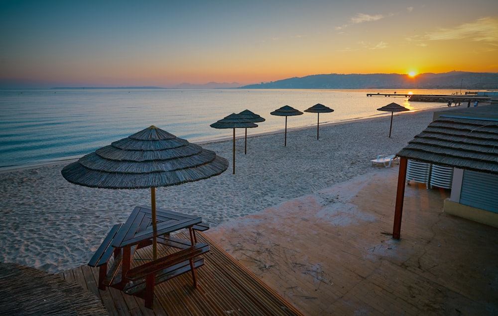 a beach with umbrellas and chairs