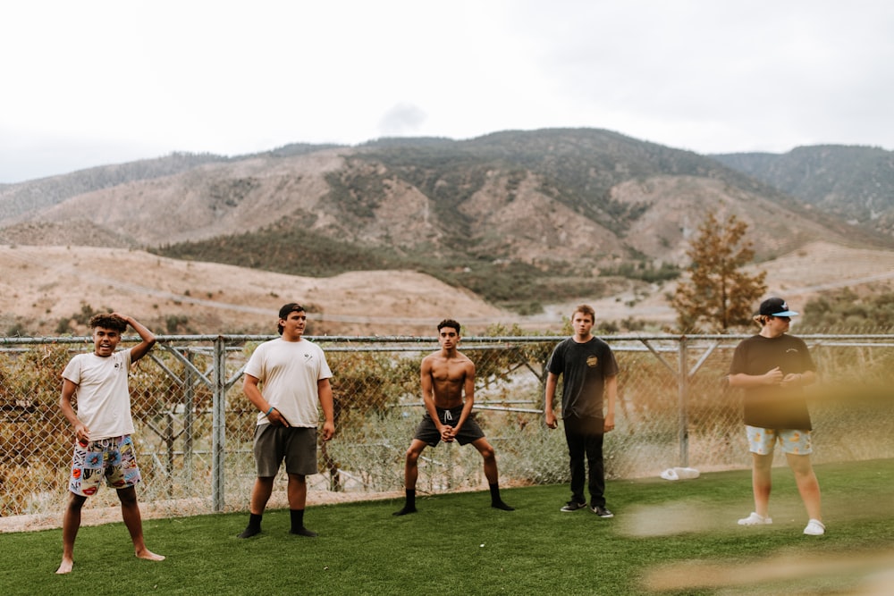 a group of men standing on a golf course