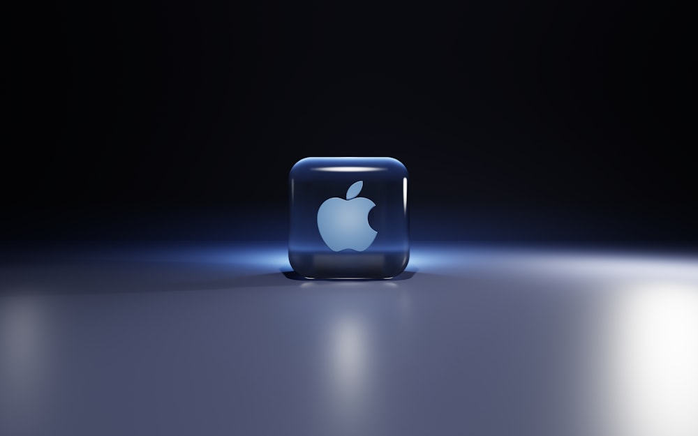 a small blue cube with a white logo on it