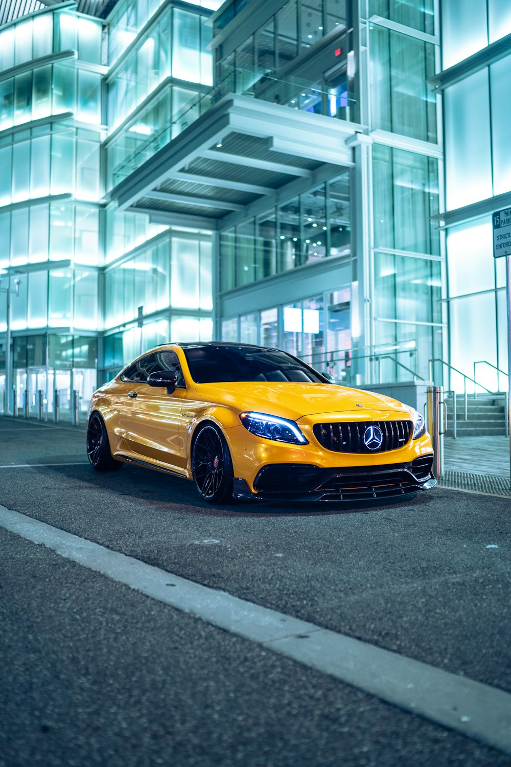 a yellow sports car parked outside a building